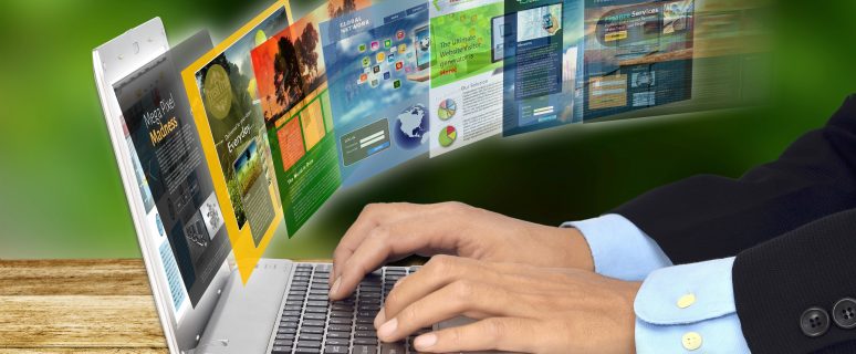 Businessman hand browsing internet websites on his laptop